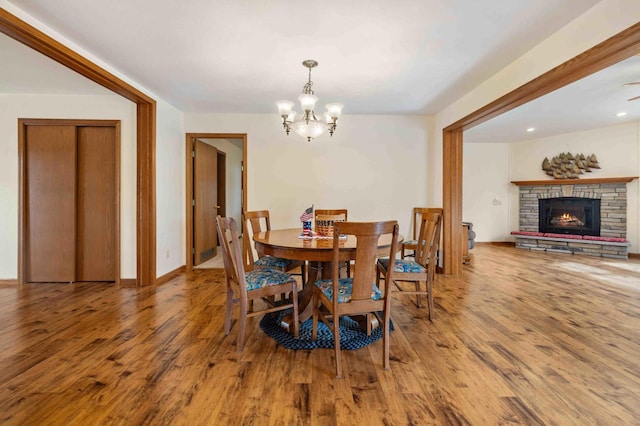 505 Superior Ave, Crosby, MN 56441 - dining space with wood finished floors, a chandelier, and a fireplace