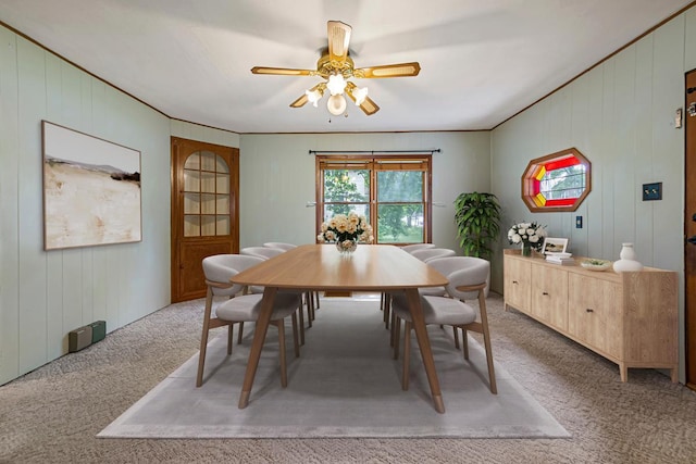 912 State St N, Waseca, MN 56093 - dining space with light colored carpet, ceiling fan, and wood walls