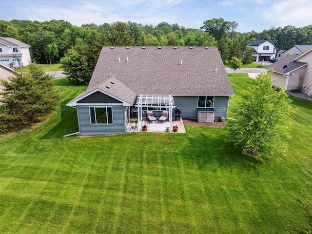 9308 Viking St, Brainerd, MN 56401 - back of house with a patio, a lawn, roof with shingles, and a pergola