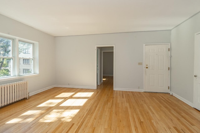 3128 Bde Maka Ska Blvd Unit 415, Minneapolis, MN 55416 - spare room featuring radiator heating unit, light wood-style floors, and baseboards