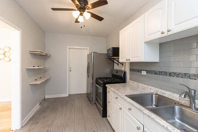 3128 Bde Maka Ska Blvd Unit 415, Minneapolis, MN 55416 - kitchen with stainless steel range with gas stovetop, a sink, black microwave, a ceiling fan, and light wood-style floors