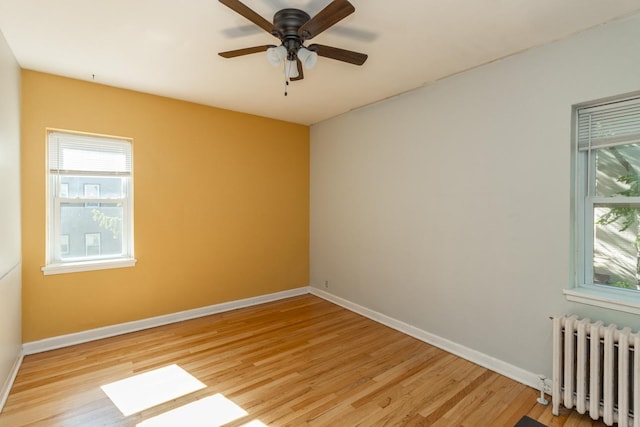 3128 Bde Maka Ska Blvd Unit 415, Minneapolis, MN 55416 - empty room with radiator heating unit, healthy amount of natural light, light wood finished floors, and baseboards