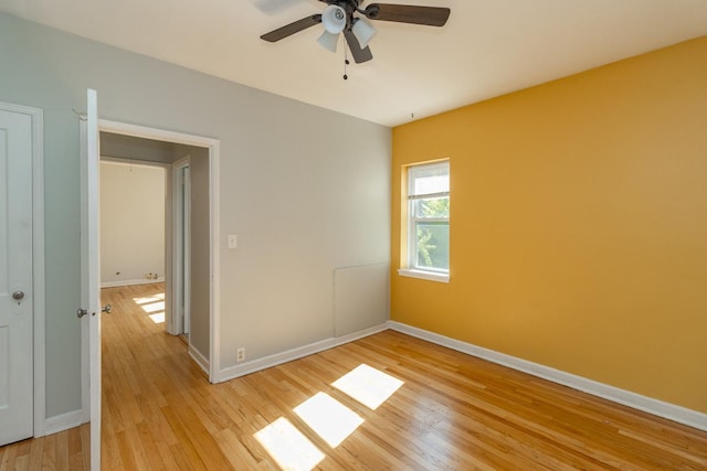 3128 Bde Maka Ska Blvd Unit 415, Minneapolis, MN 55416 - unfurnished room featuring light wood finished floors, ceiling fan, and baseboards