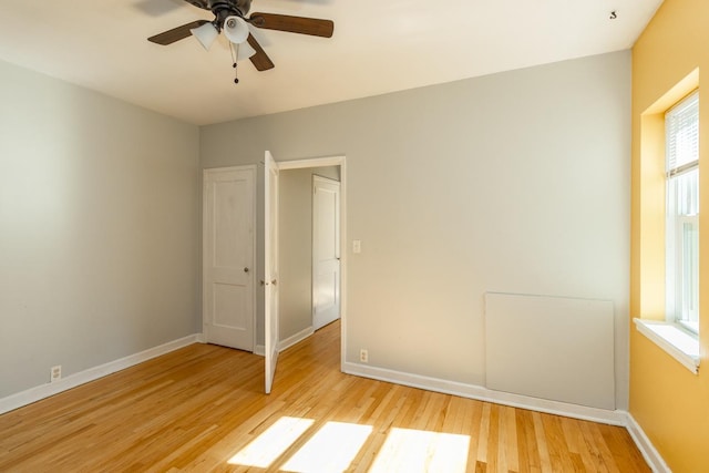 3128 Bde Maka Ska Blvd Unit 415, Minneapolis, MN 55416 - unfurnished room featuring light wood finished floors, a ceiling fan, and baseboards