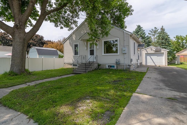 509 8th Ave SE, Waseca, MN 56093 - bungalow featuring asphalt driveway, an outbuilding, and a detached garage