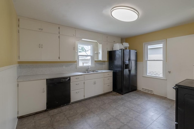 509 8th Ave SE, Waseca, MN 56093 - kitchen with black appliances, a sink, light countertops, and white cabinetry