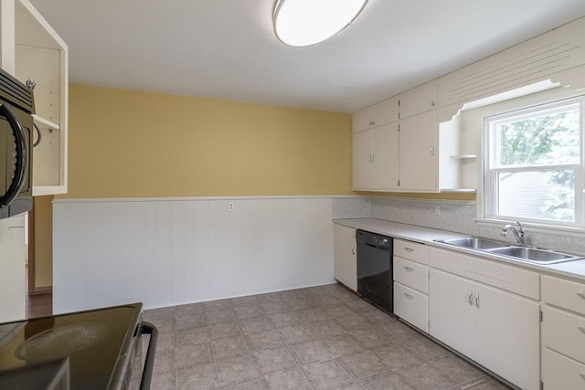 509 8th Ave SE, Waseca, MN 56093 - kitchen featuring black dishwasher, a sink, a wainscoted wall, open shelves, and white cabinets