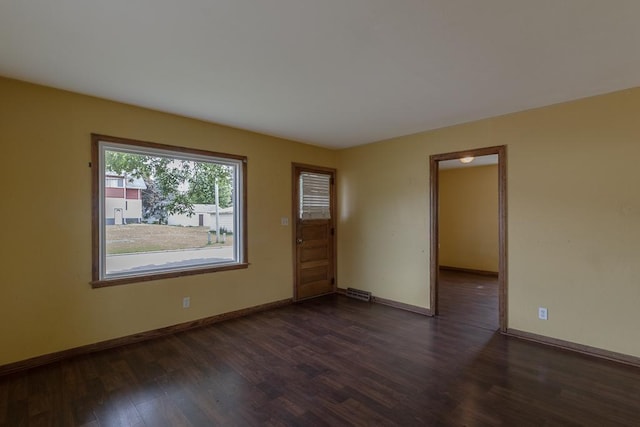 509 8th Ave SE, Waseca, MN 56093 - unfurnished room featuring dark wood finished floors and baseboards