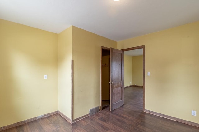 509 8th Ave SE, Waseca, MN 56093 - unfurnished room with dark wood-style flooring and baseboards