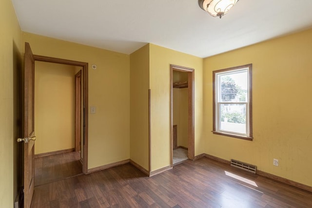509 8th Ave SE, Waseca, MN 56093 - unfurnished bedroom with dark wood finished floors, a closet, and baseboards