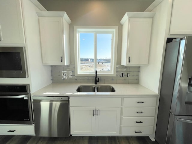 4818 163rd St N, Hugo, MN 55038 - kitchen with stainless steel appliances, a sink, backsplash, and white cabinets