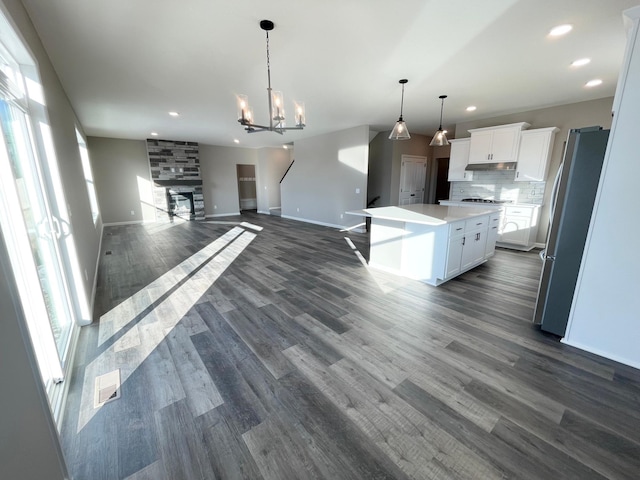 4818 163rd St N, Hugo, MN 55038 - kitchen with freestanding refrigerator, a fireplace, open floor plan, white cabinetry, and recessed lighting