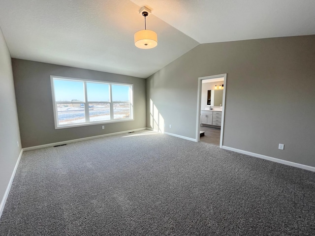 4818 163rd St N, Hugo, MN 55038 - unfurnished bedroom featuring vaulted ceiling, baseboards, carpet, and connected bathroom