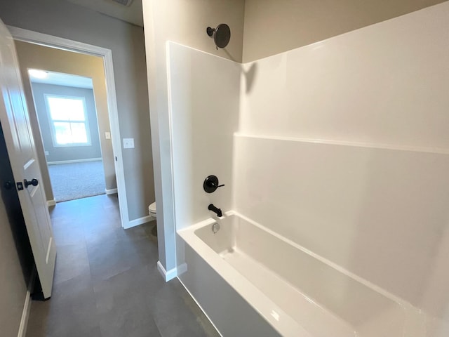 4818 163rd St N, Hugo, MN 55038 - bathroom featuring toilet, shower / bathtub combination, and baseboards