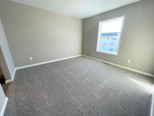 4818 163rd St N, Hugo, MN 55038 - spare room with dark carpet and baseboards