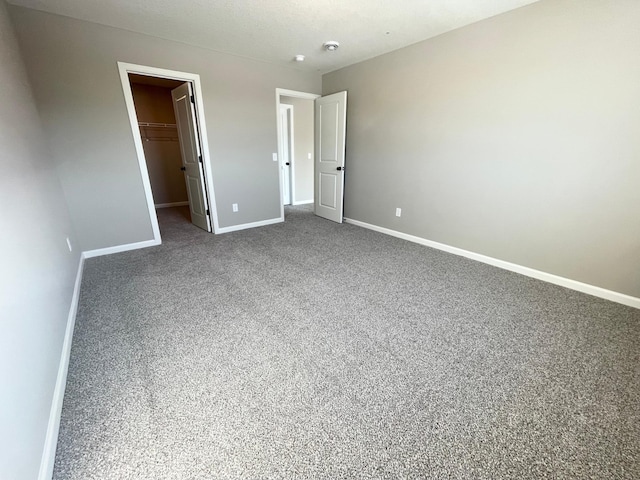 4818 163rd St N, Hugo, MN 55038 - unfurnished bedroom with baseboards, carpet, a spacious closet, and a closet
