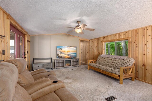134315 Lone Pine Ln, Garfield Twp, WI 54001 - living room with lofted ceiling, carpet flooring, wooden walls, ceiling fan, and a textured ceiling