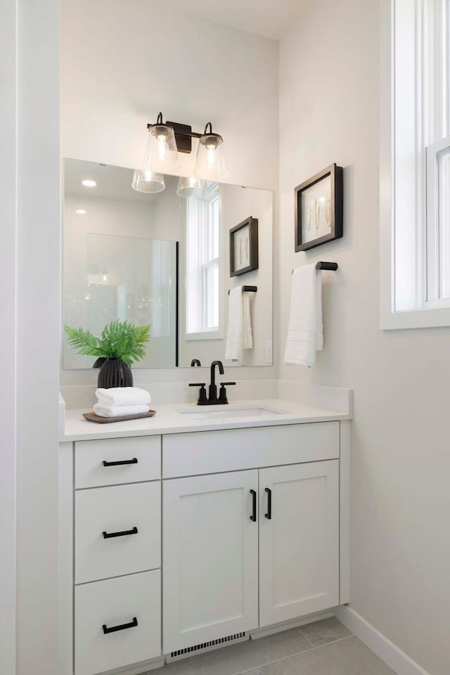 12443 Drayton Trl, Apple Valley, MN 55124 - full bathroom with vanity, baseboards, and tile patterned flooring