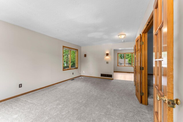 1809 Penn Ave N, Minneapolis, MN 55411 - spare room featuring light colored carpet, a textured ceiling, and baseboards