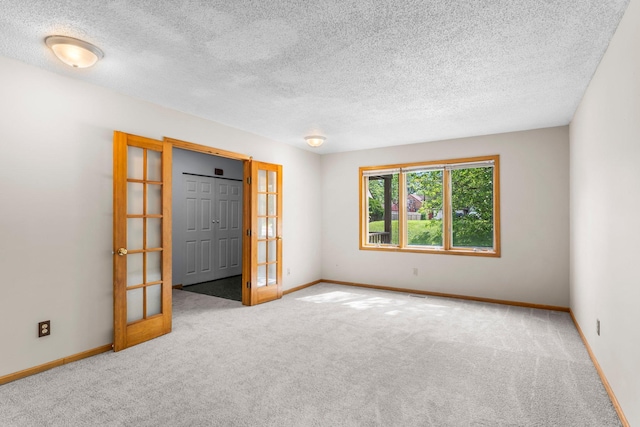 1809 Penn Ave N, Minneapolis, MN 55411 - carpeted empty room with french doors, baseboards, and a textured ceiling
