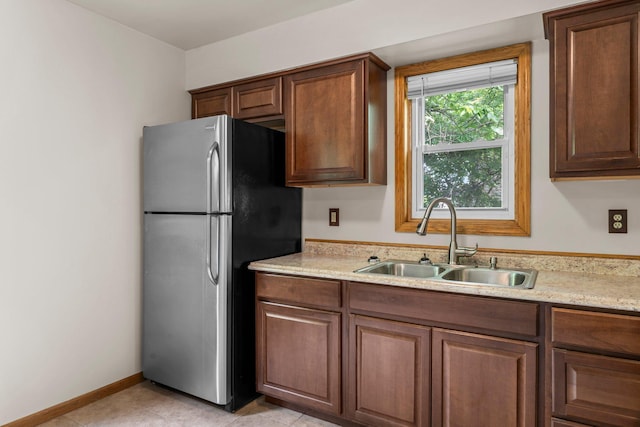 1809 Penn Ave N, Minneapolis, MN 55411 - kitchen with freestanding refrigerator, a sink, light countertops, and baseboards