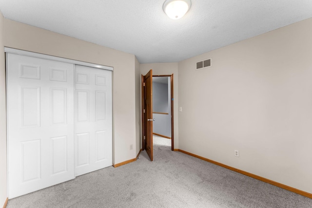 1809 Penn Ave N, Minneapolis, MN 55411 - unfurnished bedroom with light colored carpet, baseboards, a closet, and a textured ceiling