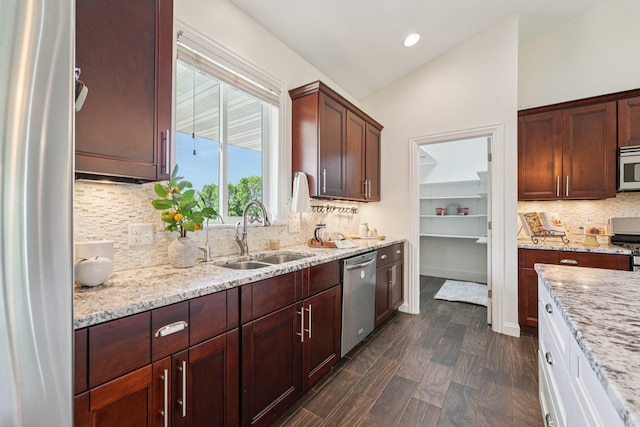 7482 250th St, New Market Twp, MN 55020 - kitchen with appliances with stainless steel finishes, light stone counters, decorative backsplash, lofted ceiling, and recessed lighting