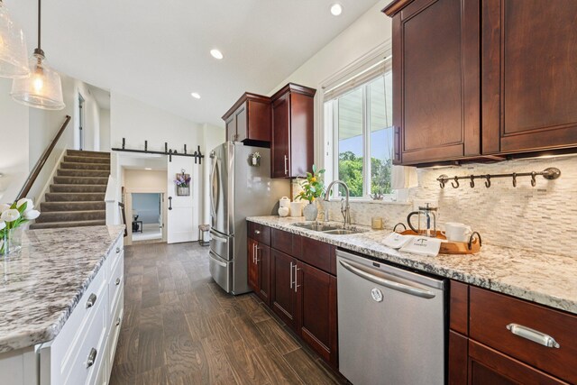 7482 250th St, New Market Twp, MN 55020 - kitchen with stainless steel appliances, tasteful backsplash, light stone counters, lofted ceiling, and recessed lighting