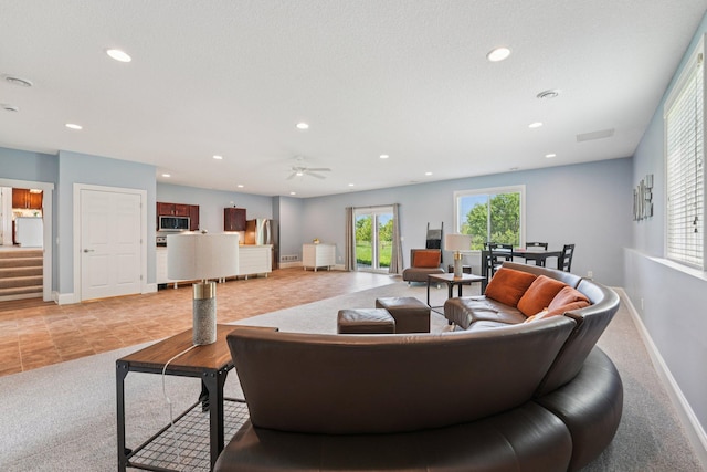 7482 250th St, New Market Twp, MN 55020 - living area with light carpet, recessed lighting, ceiling fan, light tile patterned floors, and stairway