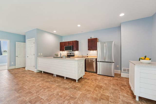 7482 250th St, New Market Twp, MN 55020 - kitchen with stainless steel appliances, light countertops, a peninsula, recessed lighting, and dark brown cabinets