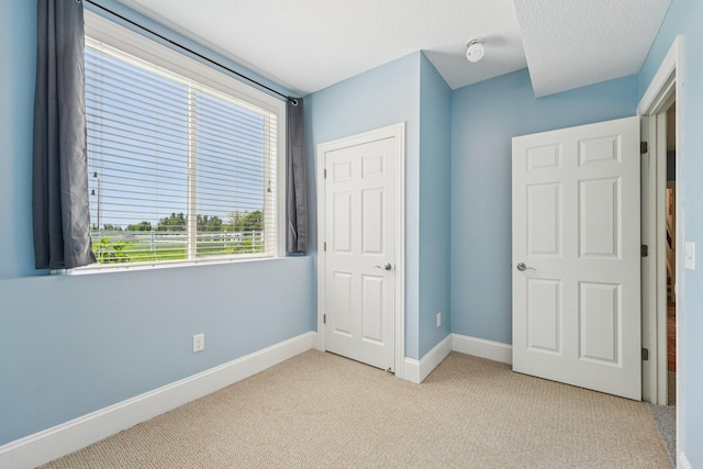7482 250th St, New Market Twp, MN 55020 - unfurnished bedroom with light colored carpet and baseboards