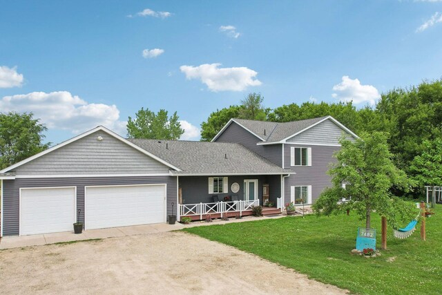7482 250th St, New Market Twp, MN 55020 - view of front of home featuring covered porch, a front lawn, driveway, a garage, and roof with shingles