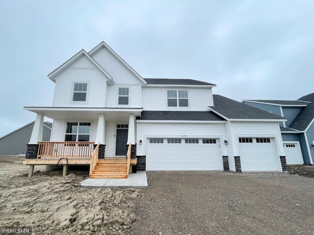 16290 Fairoaks Ave N, Hugo, MN 55038 - view of front of house with covered porch, asphalt driveway, a shingled roof, a garage, and board and batten siding