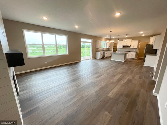 16290 Fairoaks Ave N, Hugo, MN 55038 - unfurnished living room featuring dark wood finished floors, a chandelier, and recessed lighting