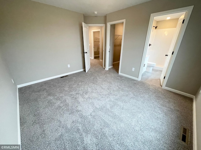 16290 Fairoaks Ave N, Hugo, MN 55038 - unfurnished bedroom with a walk in closet, a closet, carpet floors, and connected bathroom