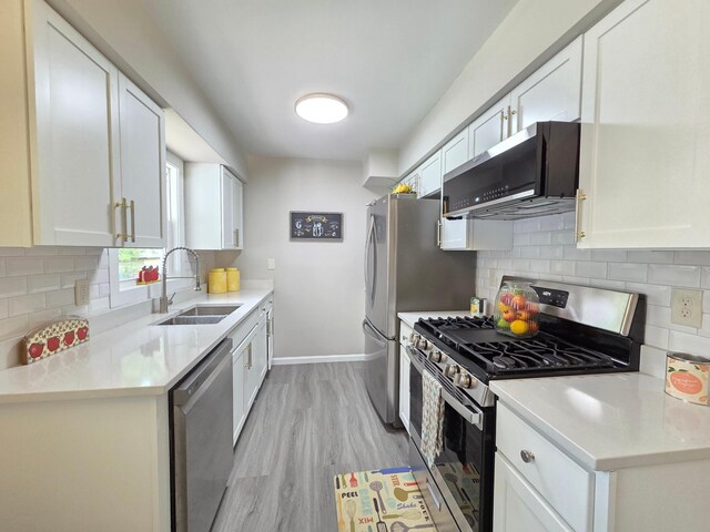 4106 Woodbine Ln N, Brooklyn Center, MN 55429 - kitchen with appliances with stainless steel finishes, a sink, white cabinets, and decorative backsplash
