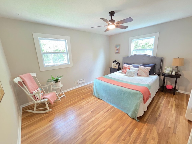 4106 Woodbine Ln N, Brooklyn Center, MN 55429 - bedroom with light wood-style floors, baseboards, and ceiling fan
