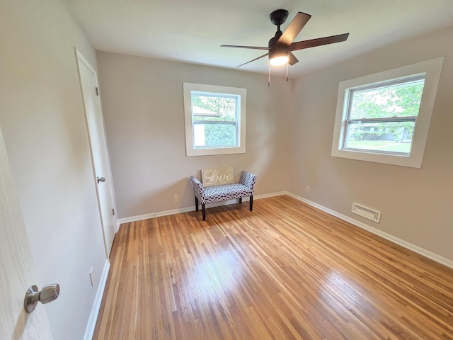 4106 Woodbine Ln N, Brooklyn Center, MN 55429 - living area with light wood finished floors, baseboards, and ceiling fan