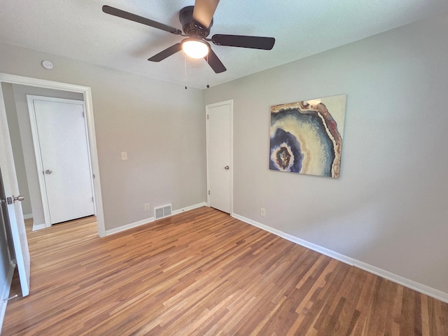 4106 Woodbine Ln N, Brooklyn Center, MN 55429 - spare room with light wood-style floors, baseboards, and ceiling fan