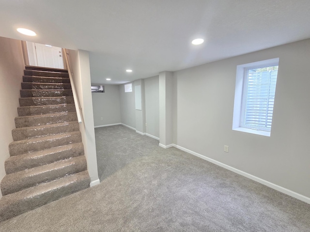 4106 Woodbine Ln N, Brooklyn Center, MN 55429 - below grade area with carpet, stairway, baseboards, and recessed lighting