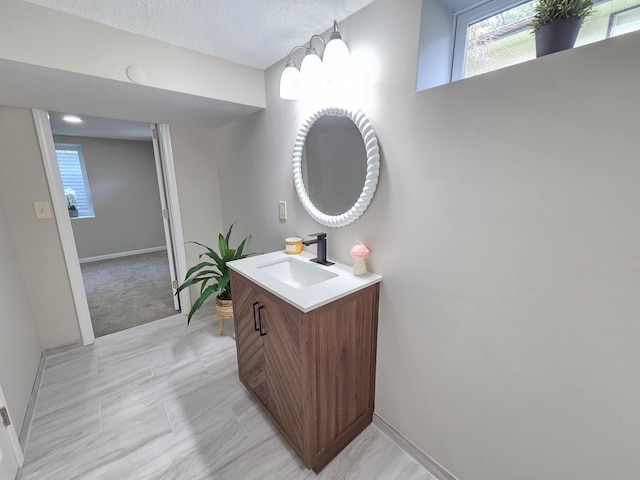 4106 Woodbine Ln N, Brooklyn Center, MN 55429 - bathroom featuring vanity, plenty of natural light, and baseboards