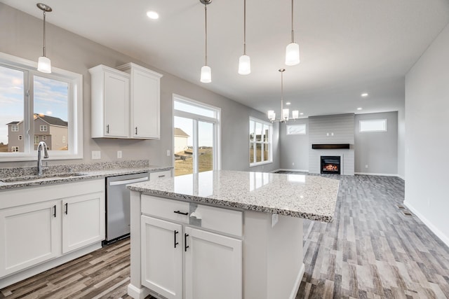 16296 Fairoaks Ave N, Hugo, MN 55038 - kitchen featuring stainless steel dishwasher, a sink, light wood-type flooring, healthy amount of natural light, and recessed lighting