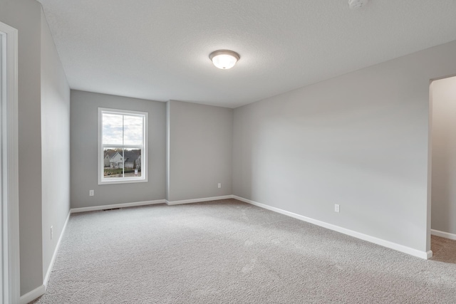 16296 Fairoaks Ave N, Hugo, MN 55038 - empty room featuring carpet, baseboards, and a textured ceiling