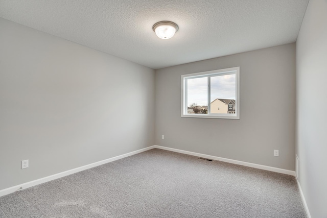 16296 Fairoaks Ave N, Hugo, MN 55038 - unfurnished room with carpet flooring, a textured ceiling, and baseboards