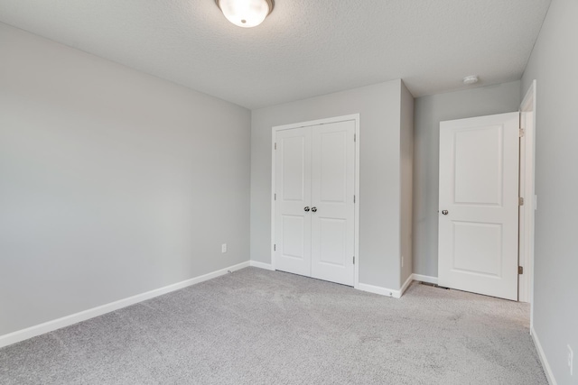 16296 Fairoaks Ave N, Hugo, MN 55038 - unfurnished bedroom with carpet floors, a closet, baseboards, and a textured ceiling
