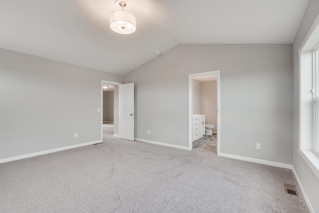 16296 Fairoaks Ave N, Hugo, MN 55038 - unfurnished bedroom with lofted ceiling, carpet, baseboards, and ensuite bath