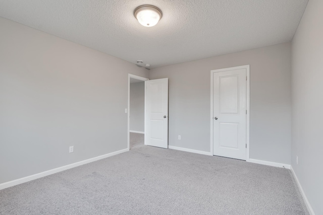 16296 Fairoaks Ave N, Hugo, MN 55038 - unfurnished bedroom with a textured ceiling, carpet flooring, and baseboards