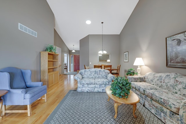 10777 181st Cir NW, Elk River, MN 55330 - living room with high vaulted ceiling, light wood-style flooring, and a chandelier