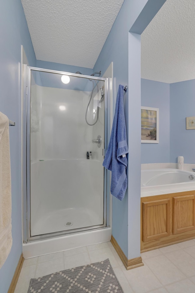 10777 181st Cir NW, Elk River, MN 55330 - full bath featuring a textured ceiling, a shower stall, tile patterned flooring, and a garden tub