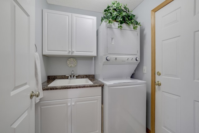 10777 181st Cir NW, Elk River, MN 55330 - laundry area featuring stacked washer / dryer, cabinet space, and a textured ceiling